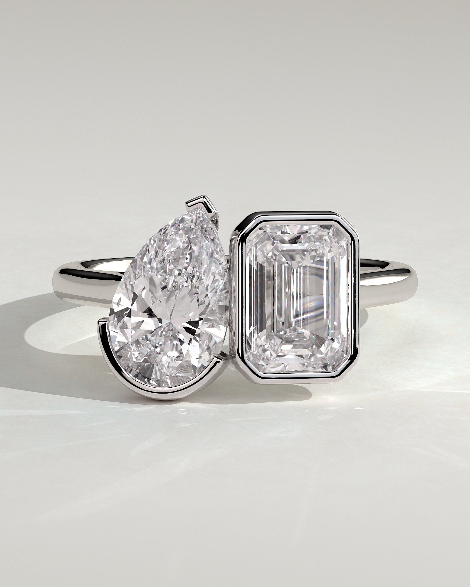 White :: Calvellae 3.3ct pear and 3.3ct emerald bezel toi et moi lab grown diamond engagement ring 360 view white gold IGI certified two stone ring