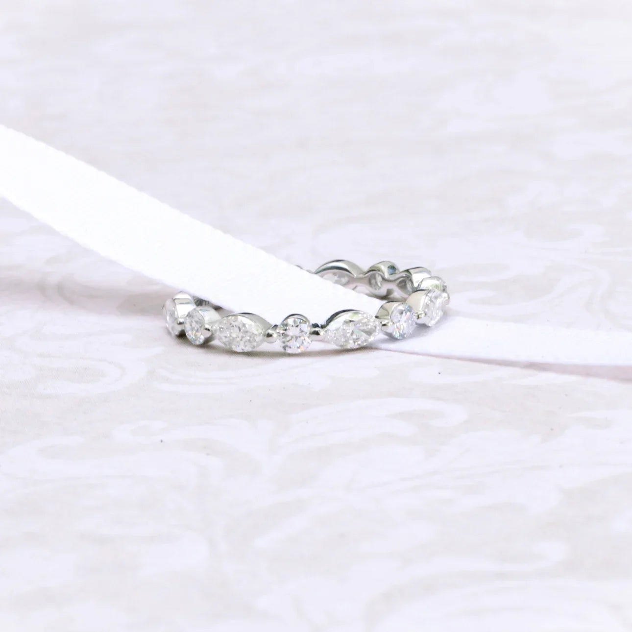 MARQUISE AND ROUND DIAMOND EAST-WEST ETERNITY BAND