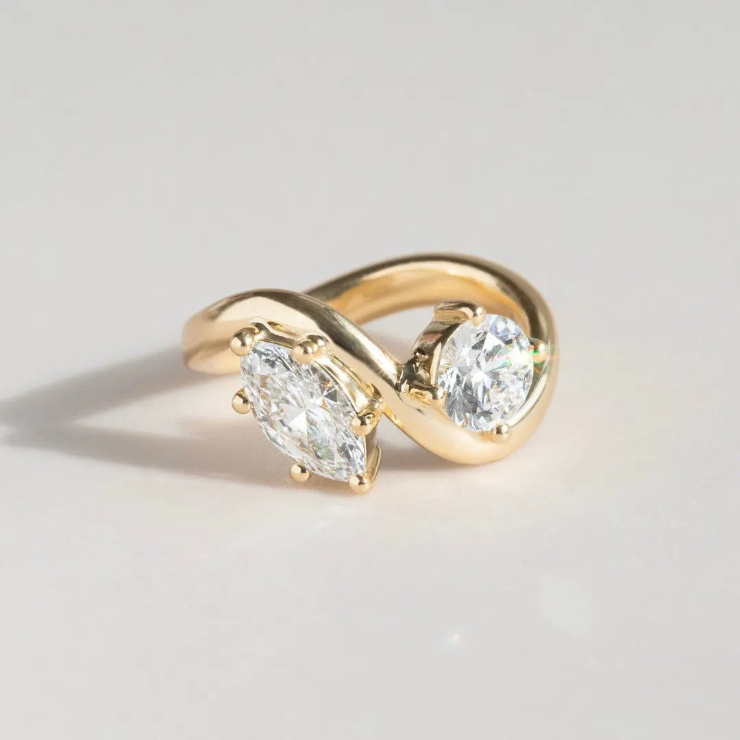 Common ::1.69 CTW Round and Marquise Toi Et Moi lab grown diamond ring in 18K yellow gold with D color VVS diamonds.