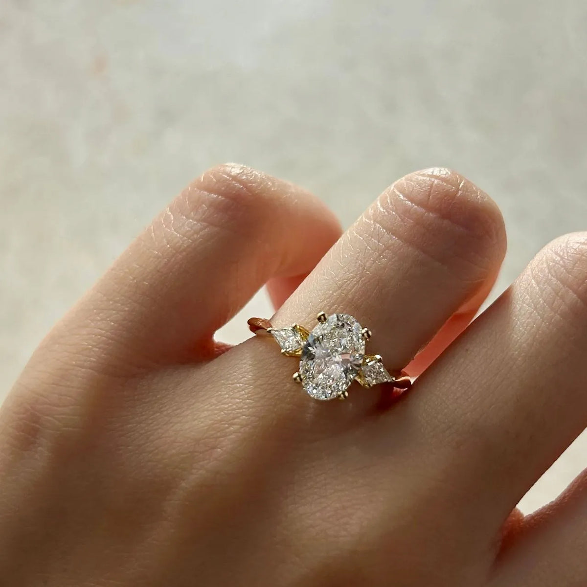 Common :: 1.50ct oval lab grown diamond ring with kite shaped side diamondsaccents