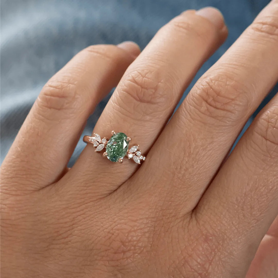 Common :: close up green oval lab diamond ring floral cluster engagement ring
