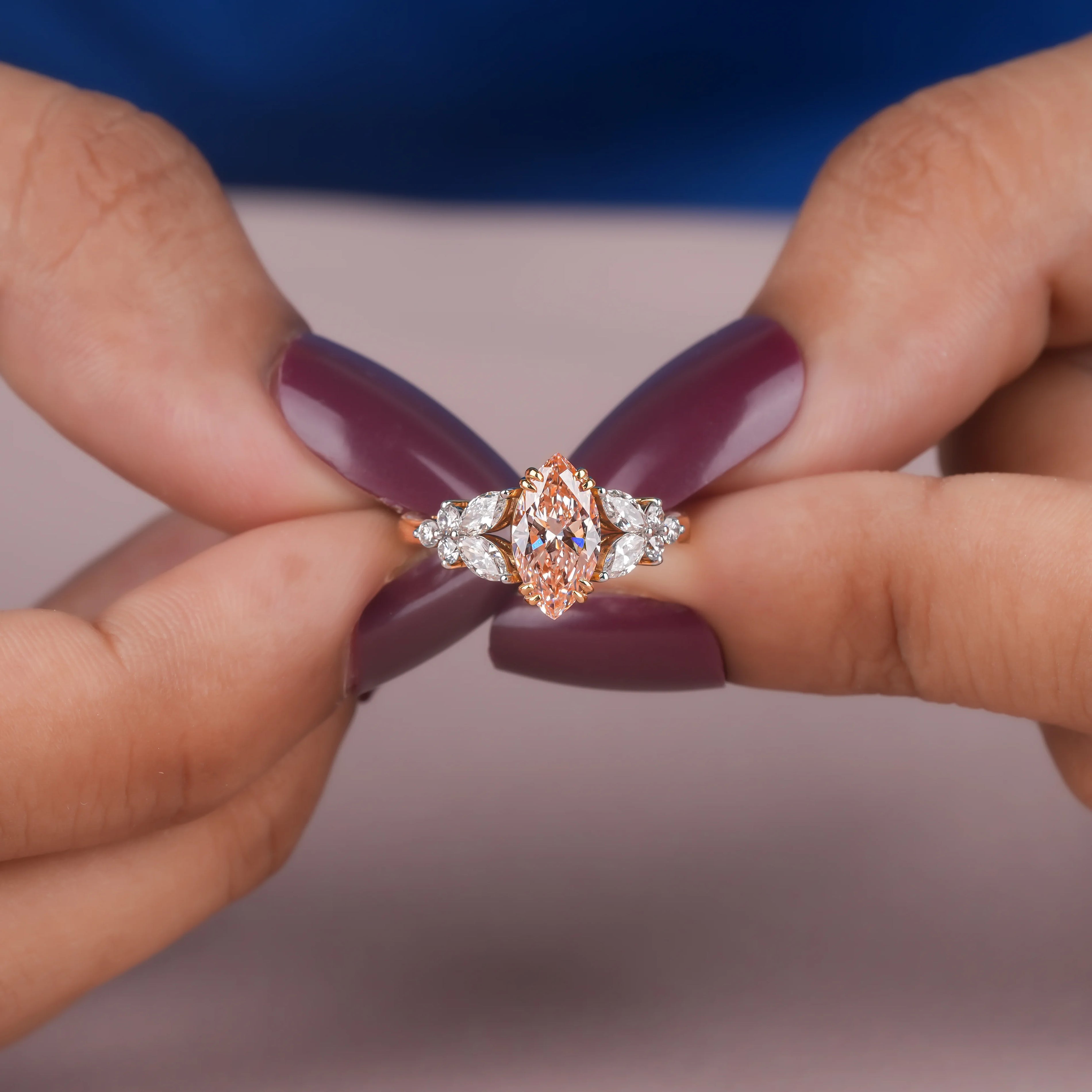Common :: 1.00CT pink marquise lab grown diamond ring with an IGI-certified center stone.