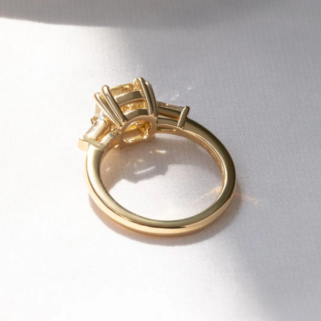 Common :: close up yellow cushion lab diamond ring brilliant three stone engagement ring