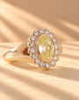 Common :: Yellow oval lab-grown diamond ring featuring an elegant halo design