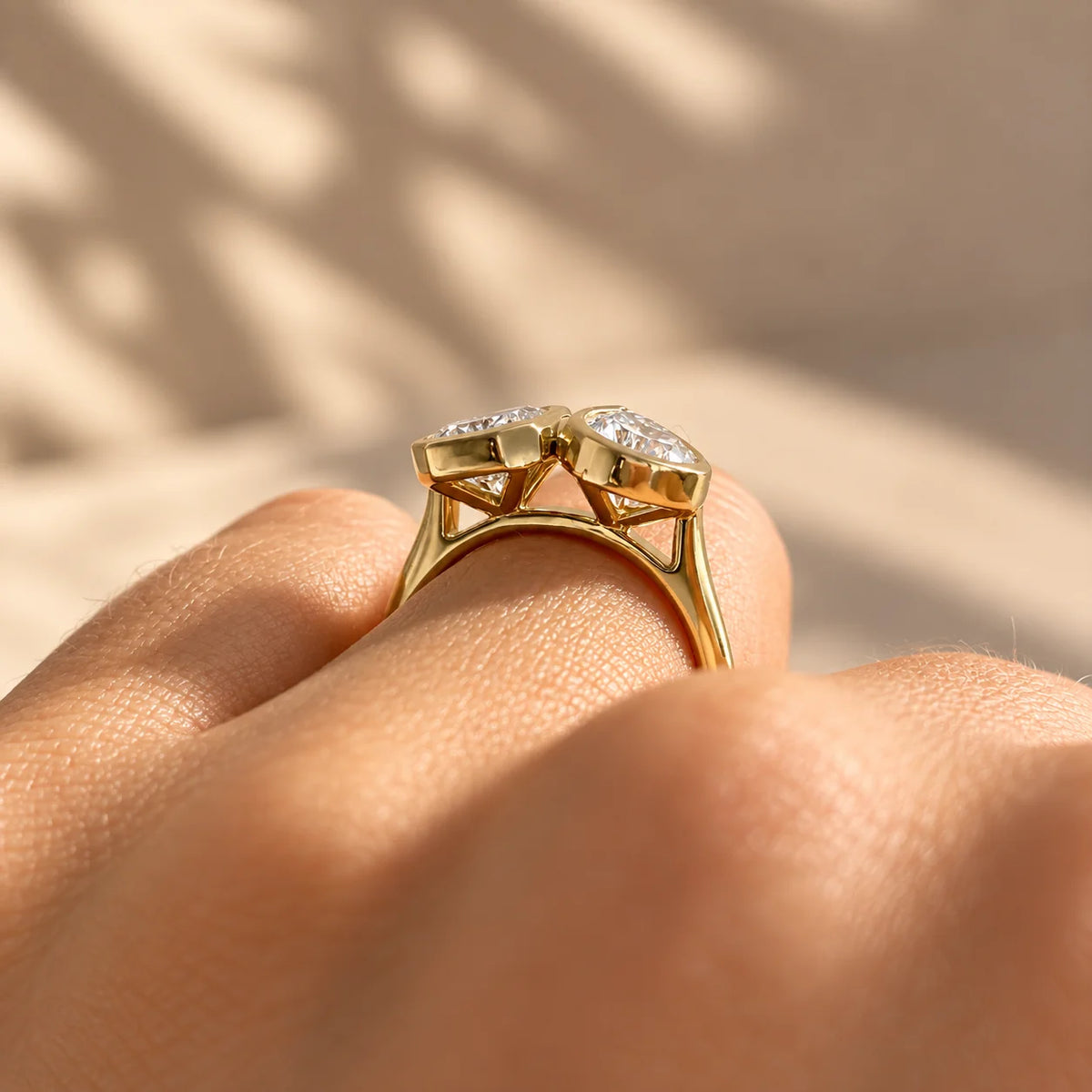 Common :: Pear Emerald two stone bezel diamond engagement ring