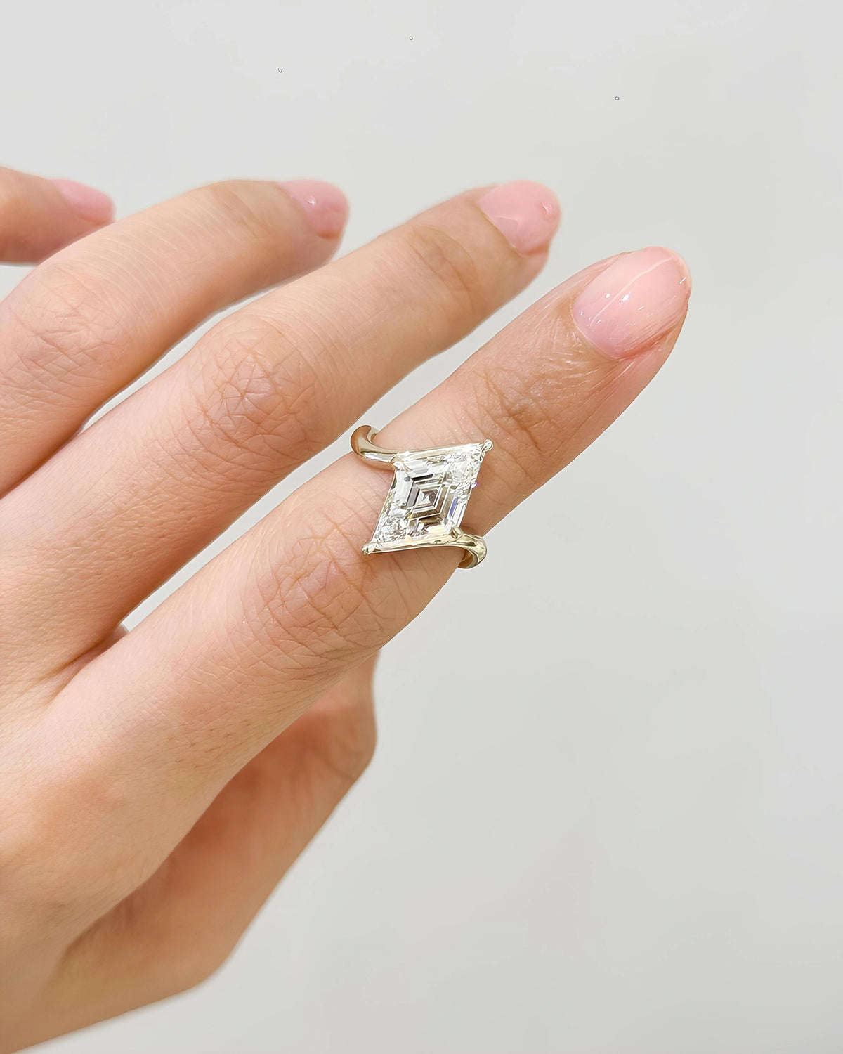 Common :: Lozenge Step Cut diamond bypass inspired engagement ring on hand