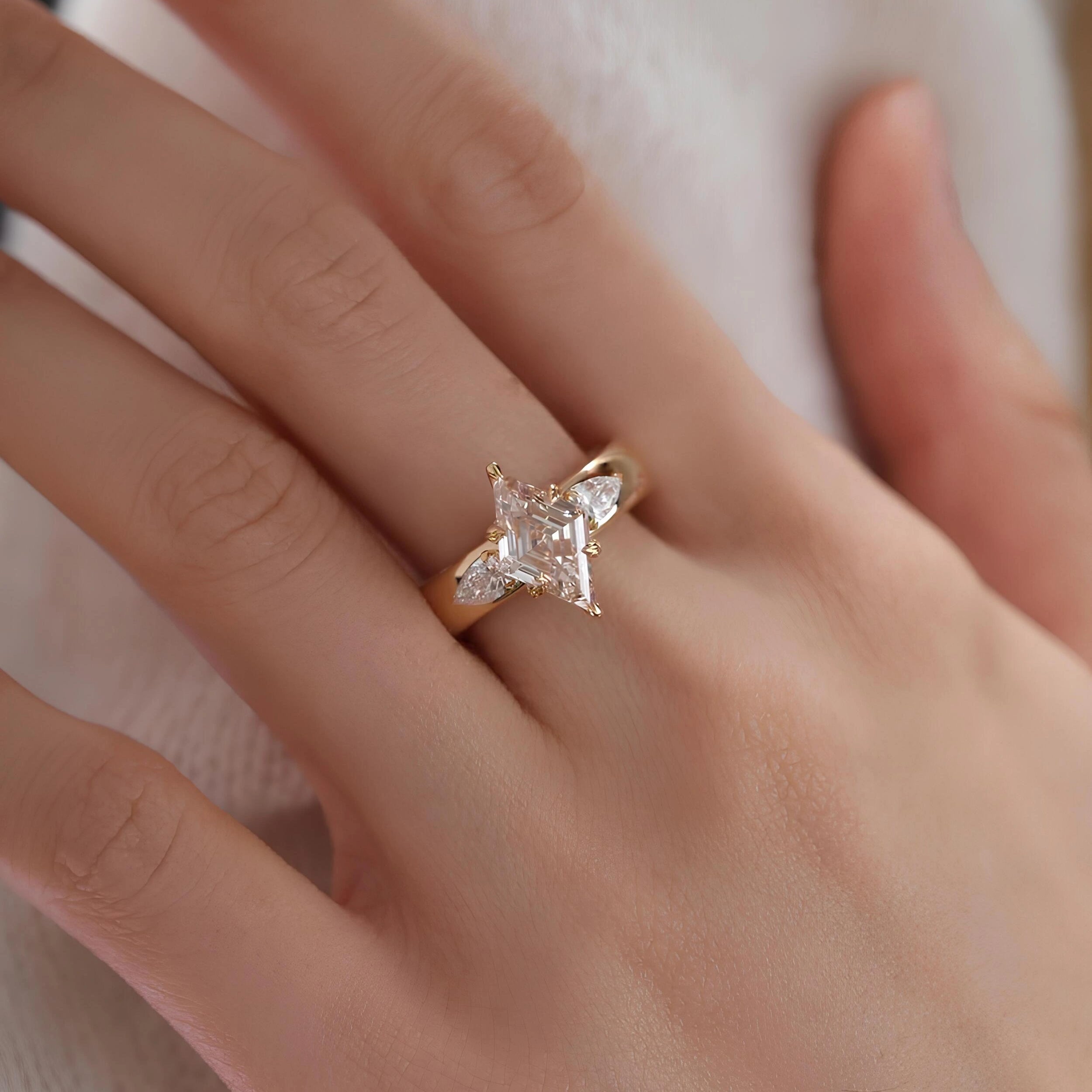 Common :: 2.00ct lozenge lab grown diamond ring with pear shaped side diamonds