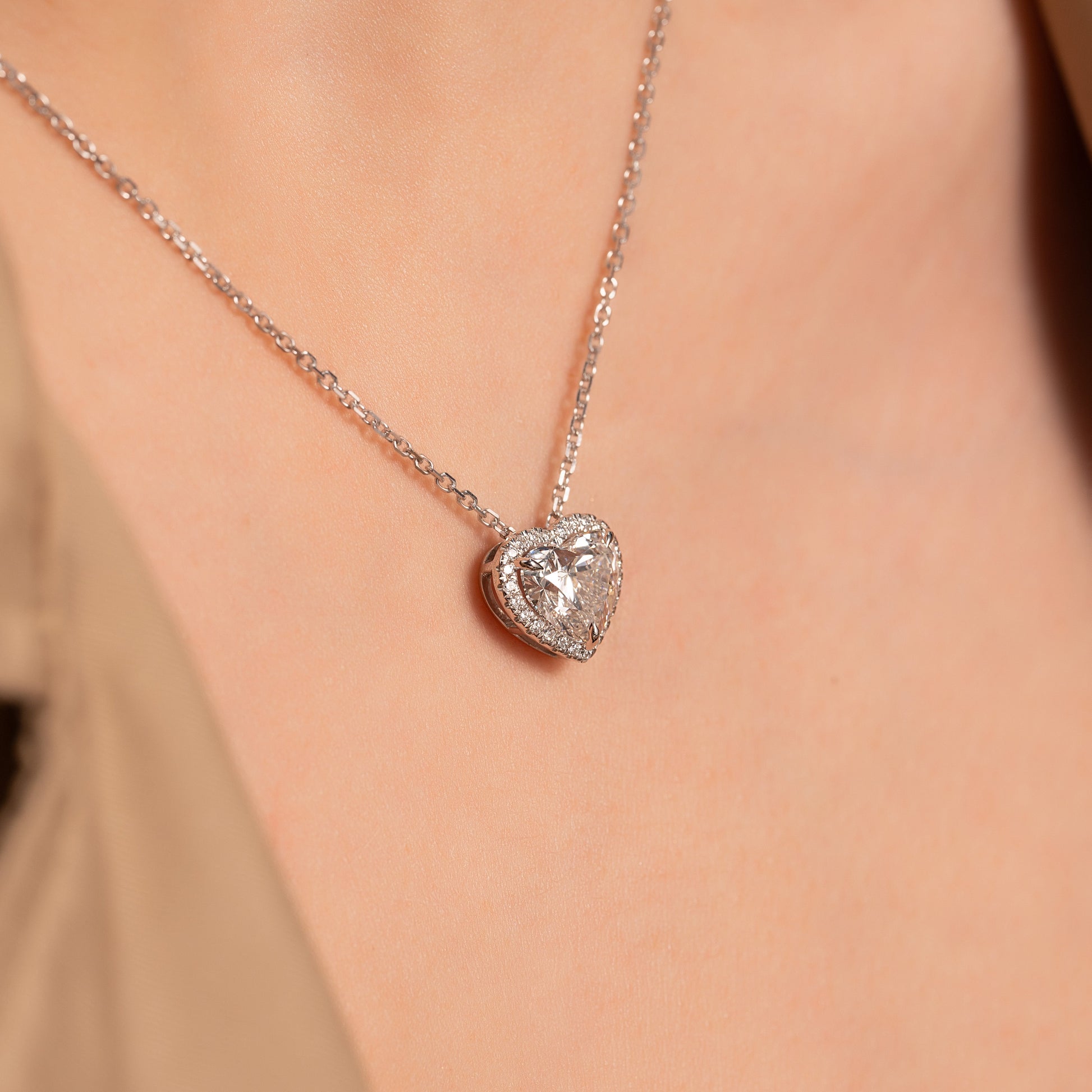 white :: 2.5 CT Arianza emerald cut halo pendant in white gold
