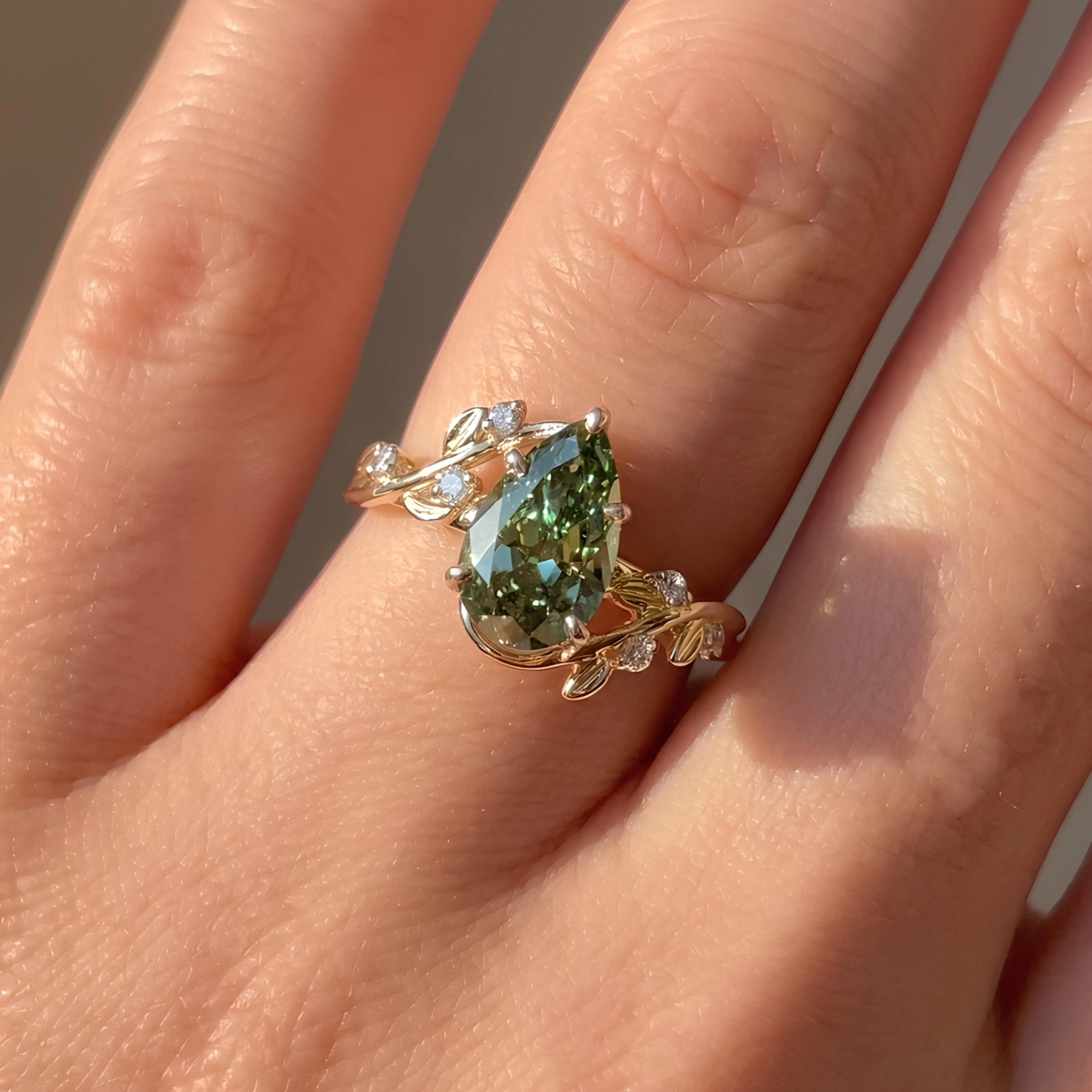 Common :: 2.00CT green pear-shaped lab grown diamond engagement ring with IGI-certified center stone.