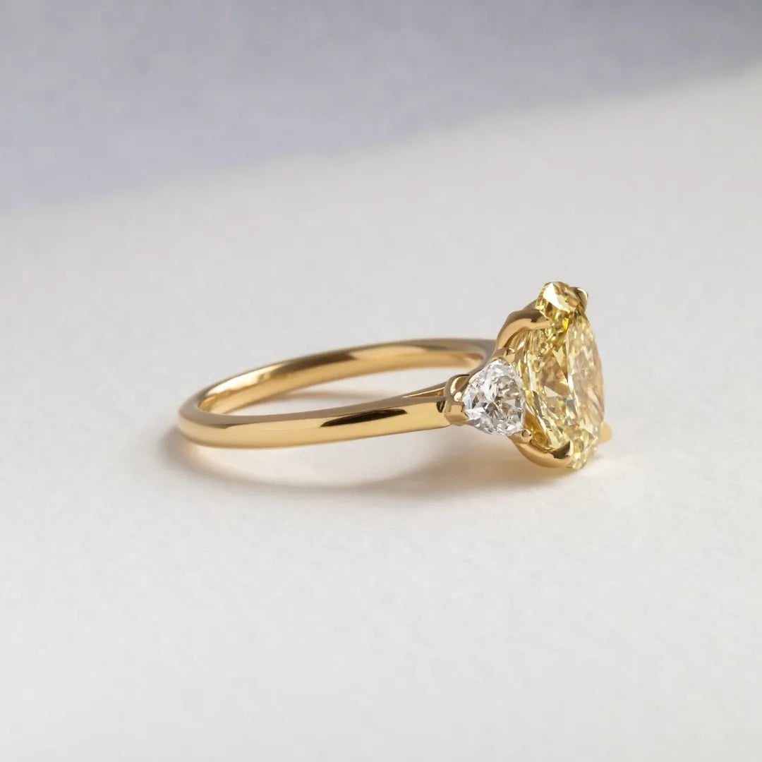 Common :: close up yellow oval lab diamond ring three stone luxury engagement ring
