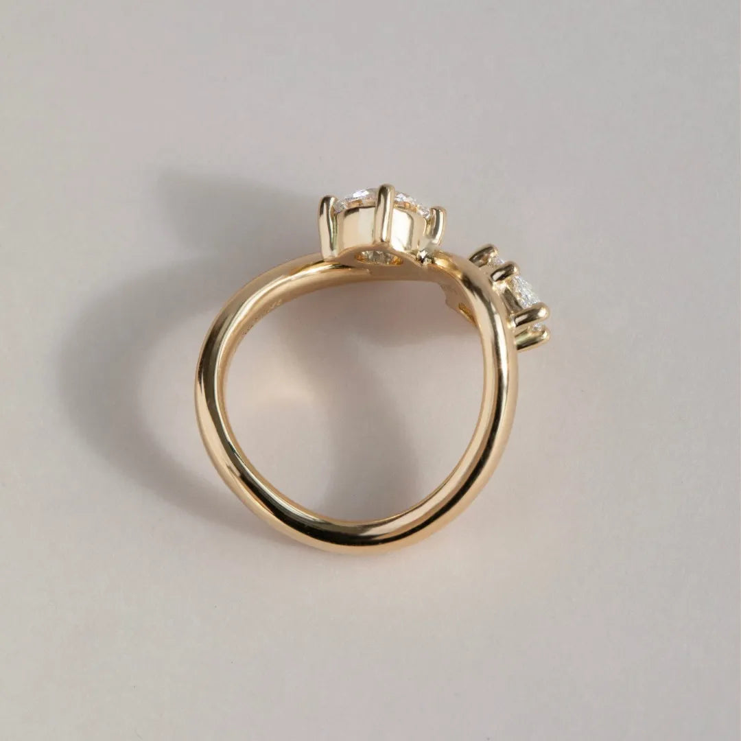 Common :: Handcrafted two stone ring showcasing round and marquise cut lab diamonds.