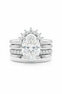 Common :: Elegant quad-layer bridal ring crafted in 18K gold with an oval center diamond.