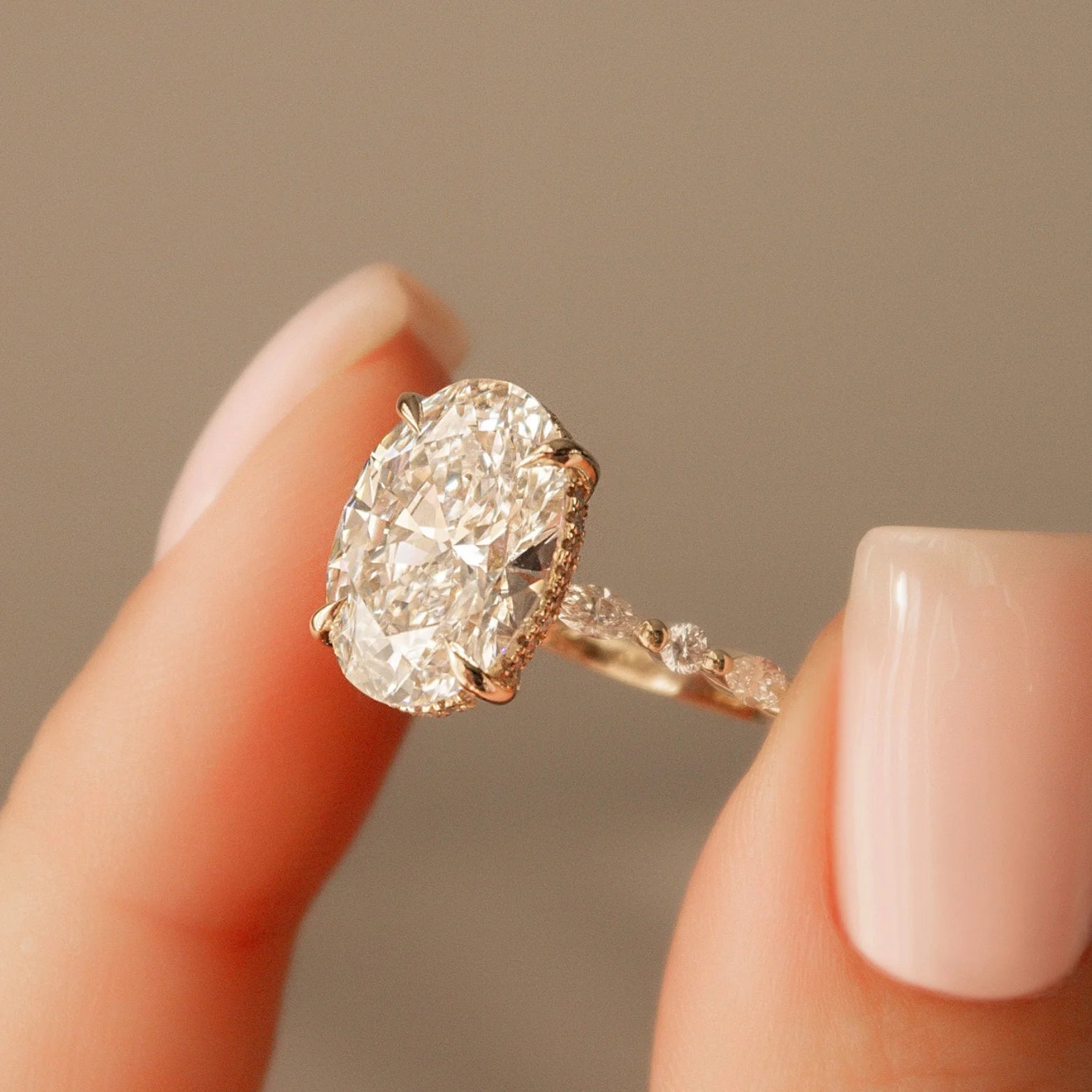 Common :: 4.50CT oval lab grown diamond engagement ring with IGI-certified center stone.