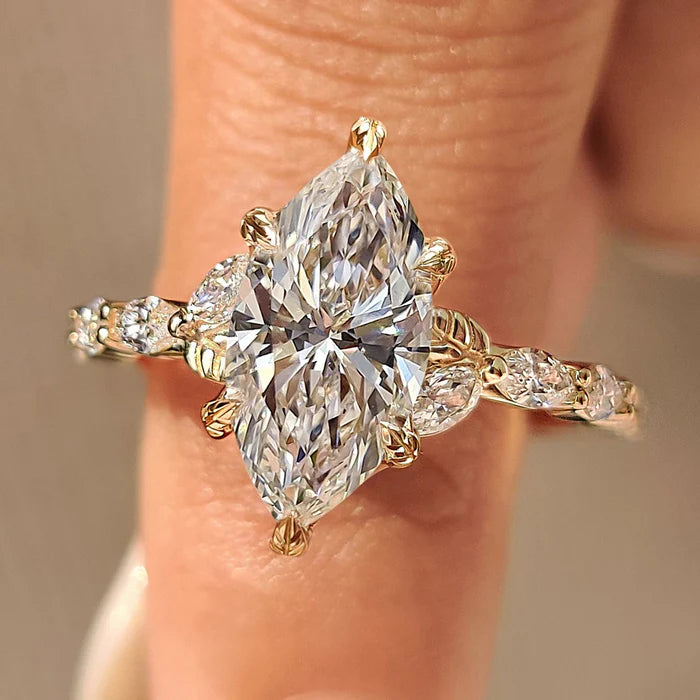 Common :: Nature inspired marquise lab grown diamond engagement ring featuring a brilliant marquise center stone with delicate leaf-inspired diamond accents.