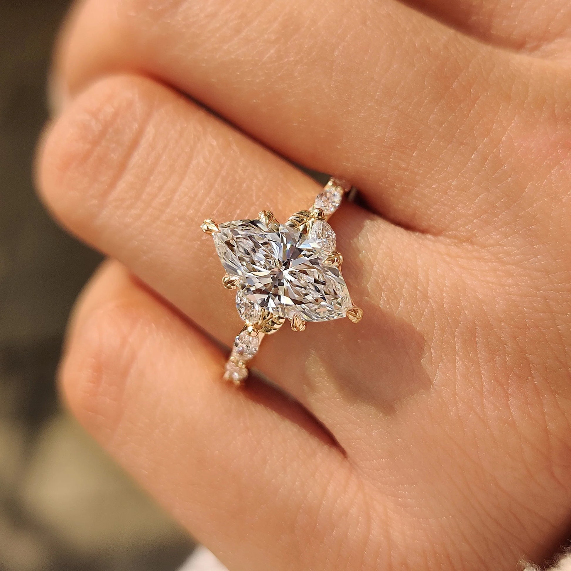 Common :: Vintage-inspired nature engagement ring featuring a marquise diamond and intricate leaf-inspired accents.