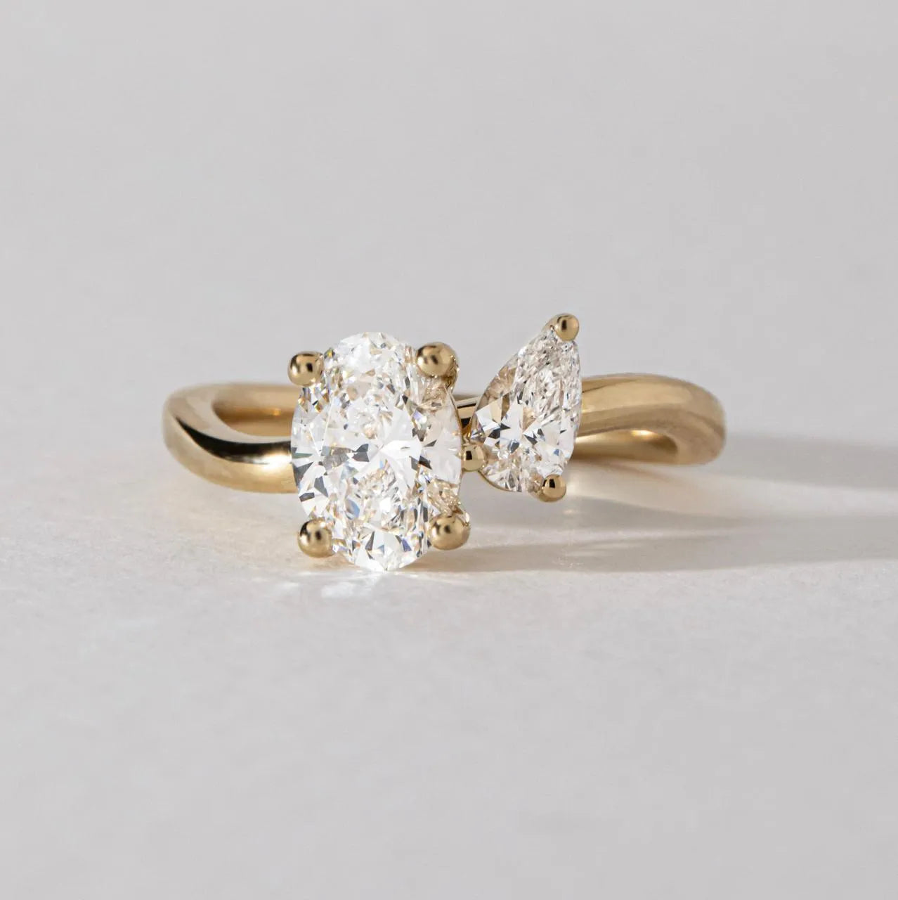 Common :: 1.57 CTW Oval and Pear Toi Et Moi lab grown diamond engagement ring in 18K yellow gold.