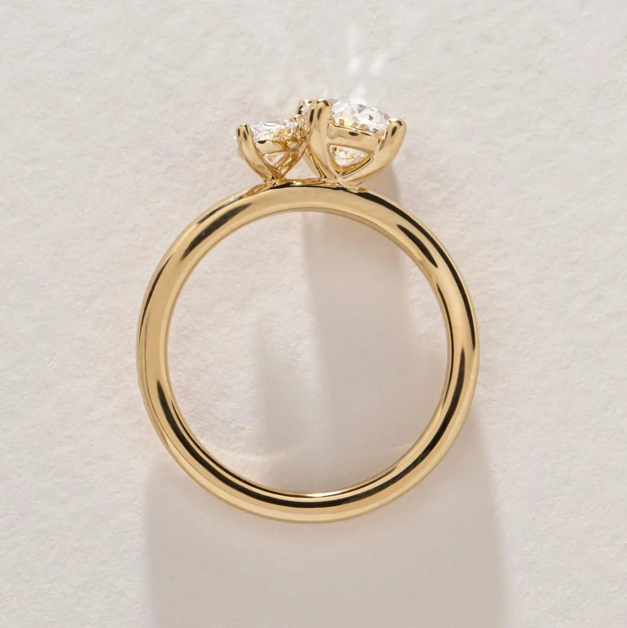 Common :: Handcrafted two stone engagement ring with oval and pear cut diamonds.