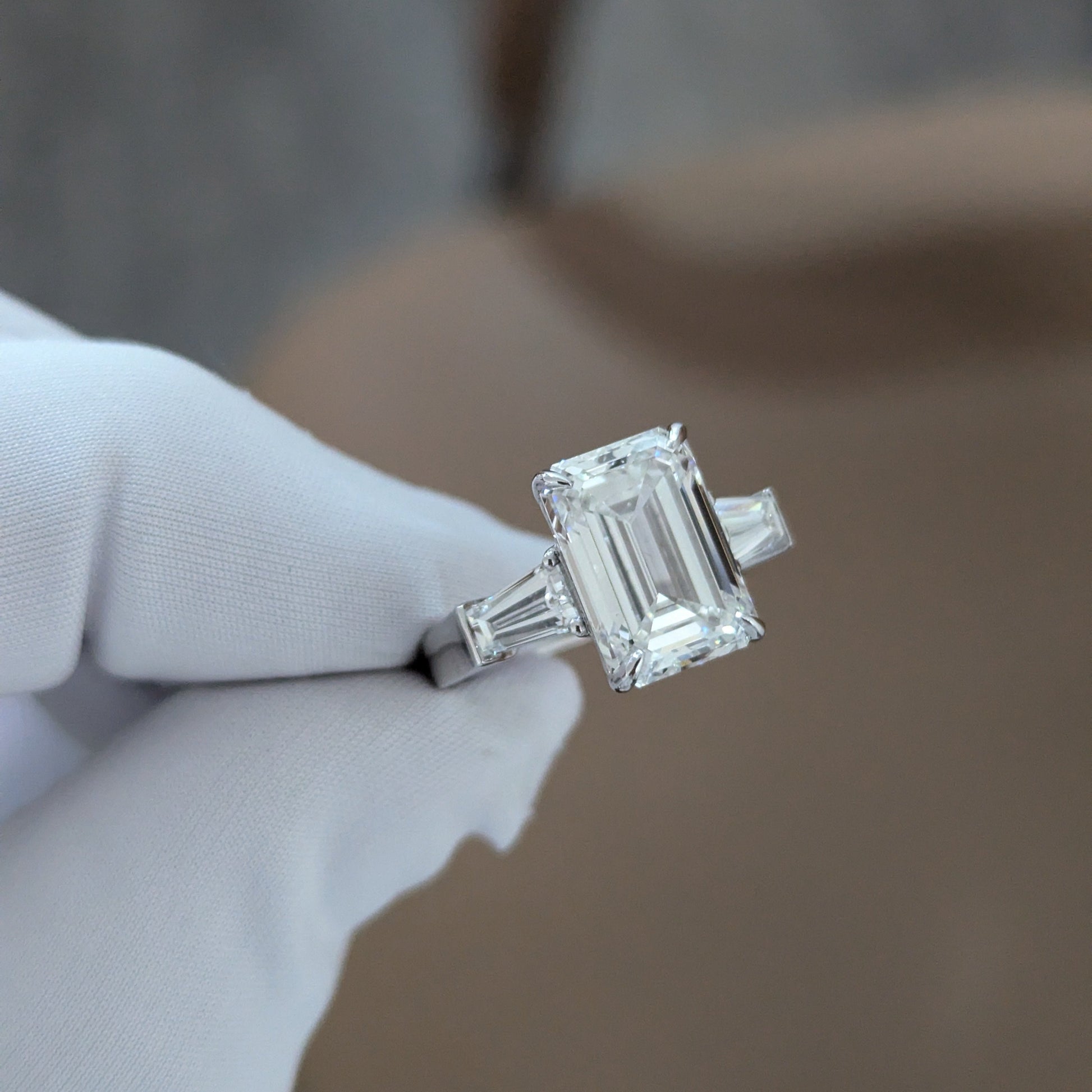 Emerald 5.80tcw Lab Diamond Three Stone Ring | IGI Certified | Tapered Baguette Side Stones