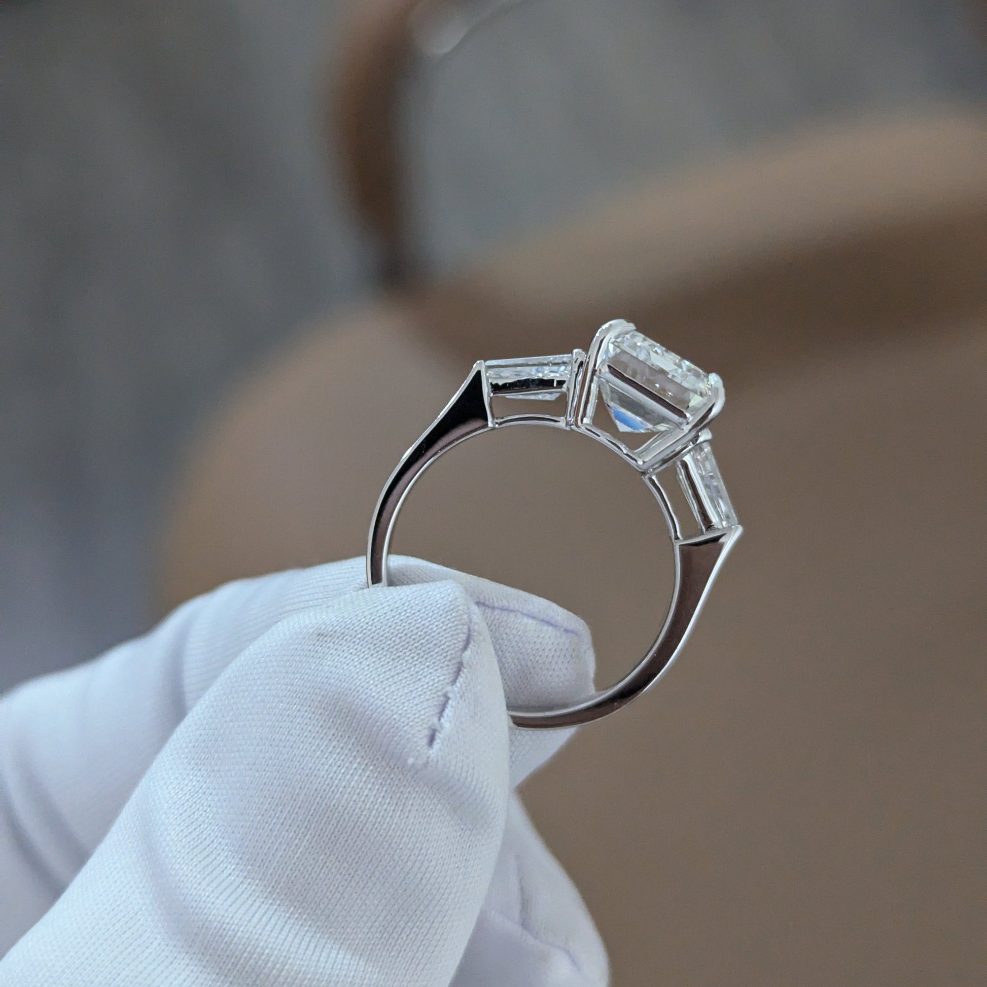 Emerald 5.80tcw Lab Diamond Three Stone Ring | IGI Certified | Tapered Baguette Side Stones