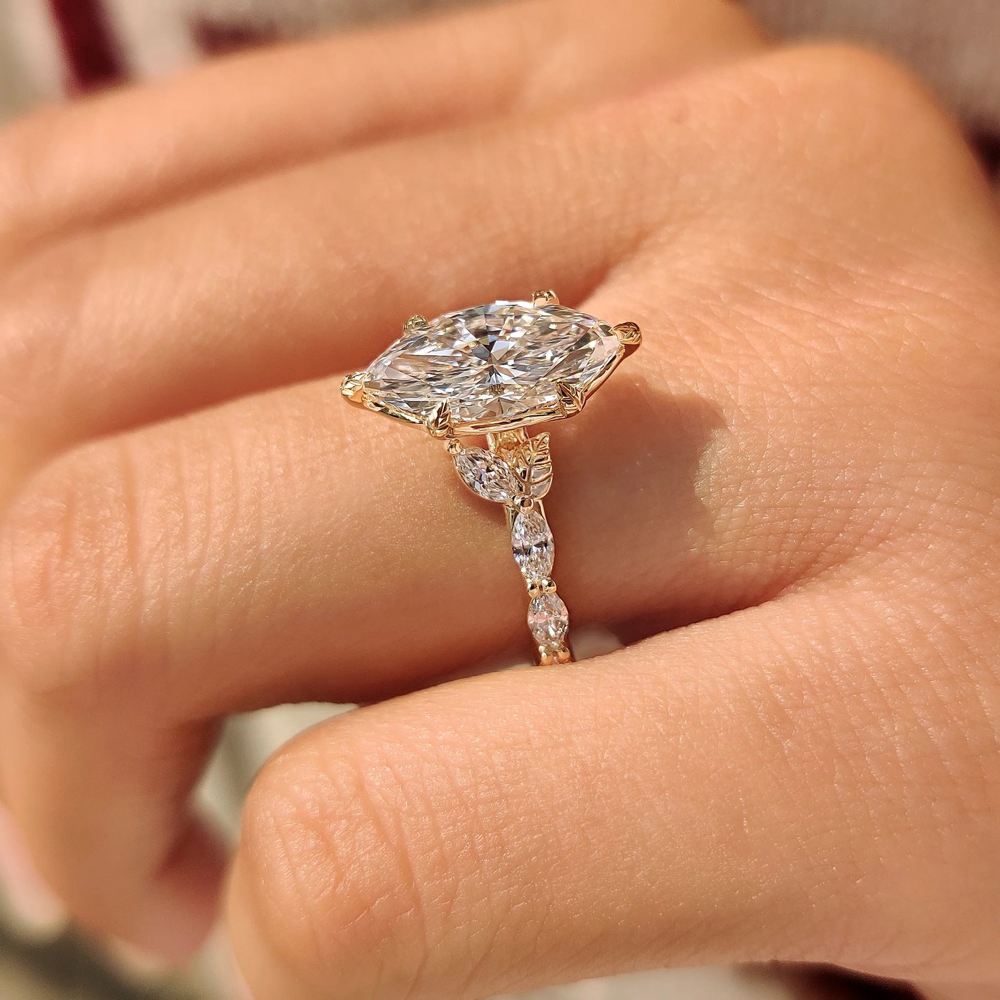 Common :: Fine jewelry engagement ring featuring a marquise cut lab grown diamond in a romantic floral setting.