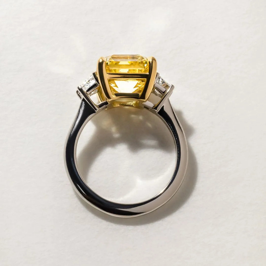 Common :: close up 5 carat yellow square emerald diamond engagement ring three stone design