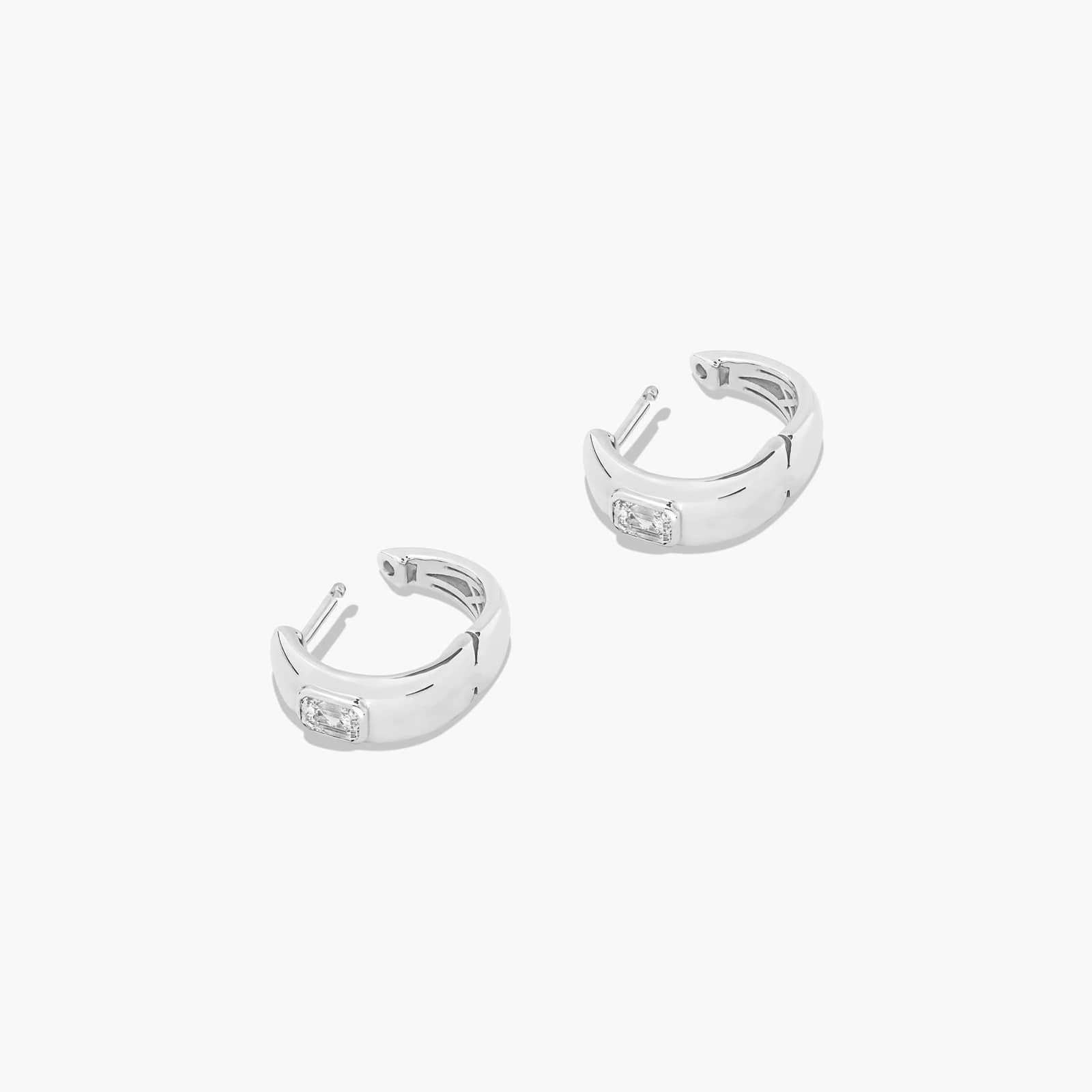 White :: delicate emerald lab grown diamond huggie earrings bezel set white gold subtle luxury everyday jewelry