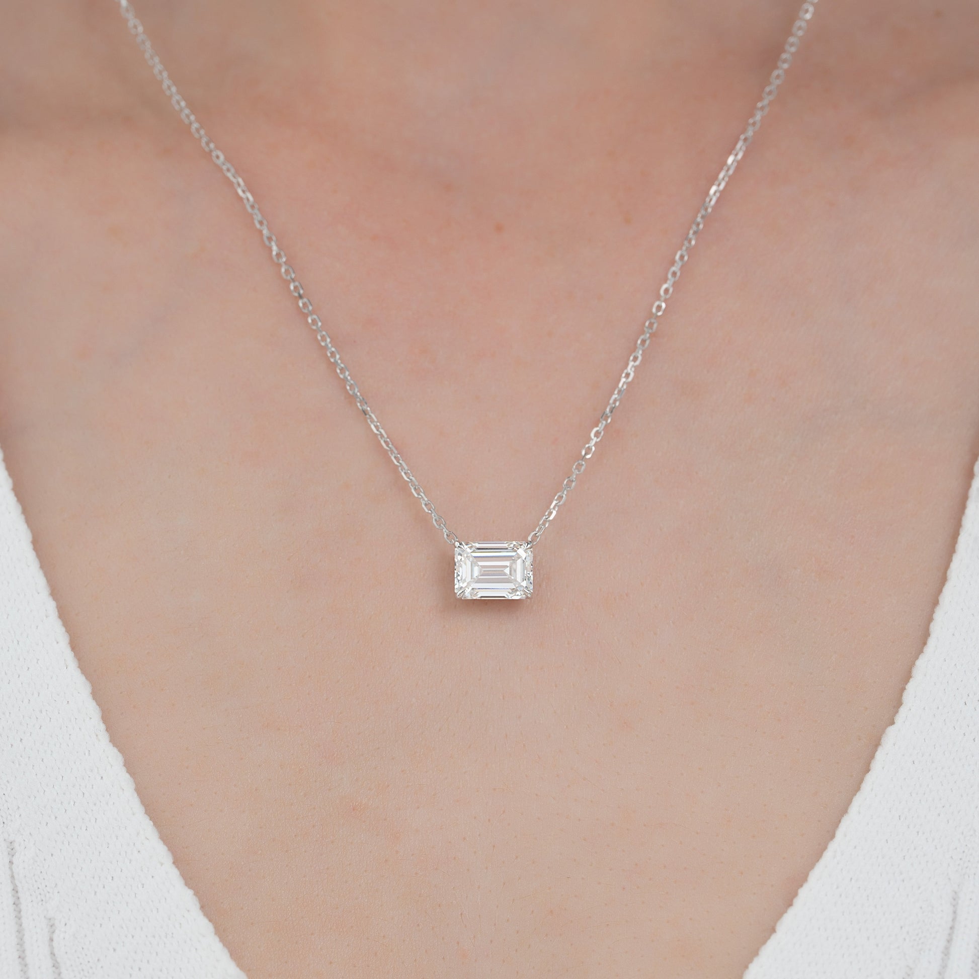 white :: 1 carat emerald cut diamond necklace featuring elegant brilliance