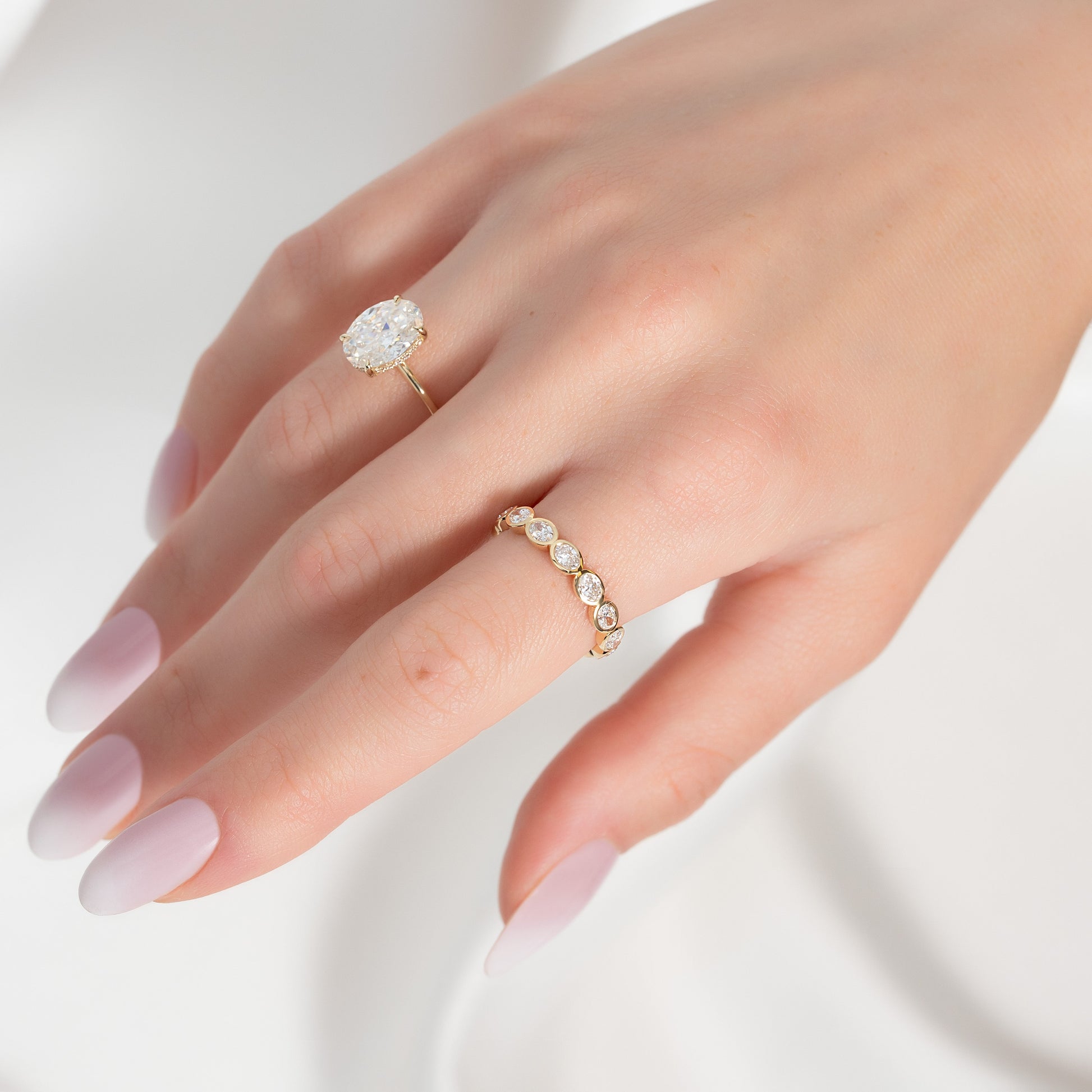Yellow :: 1.4 carat oval east west bezel lab diamond eternity ring yellow gold horizontal band