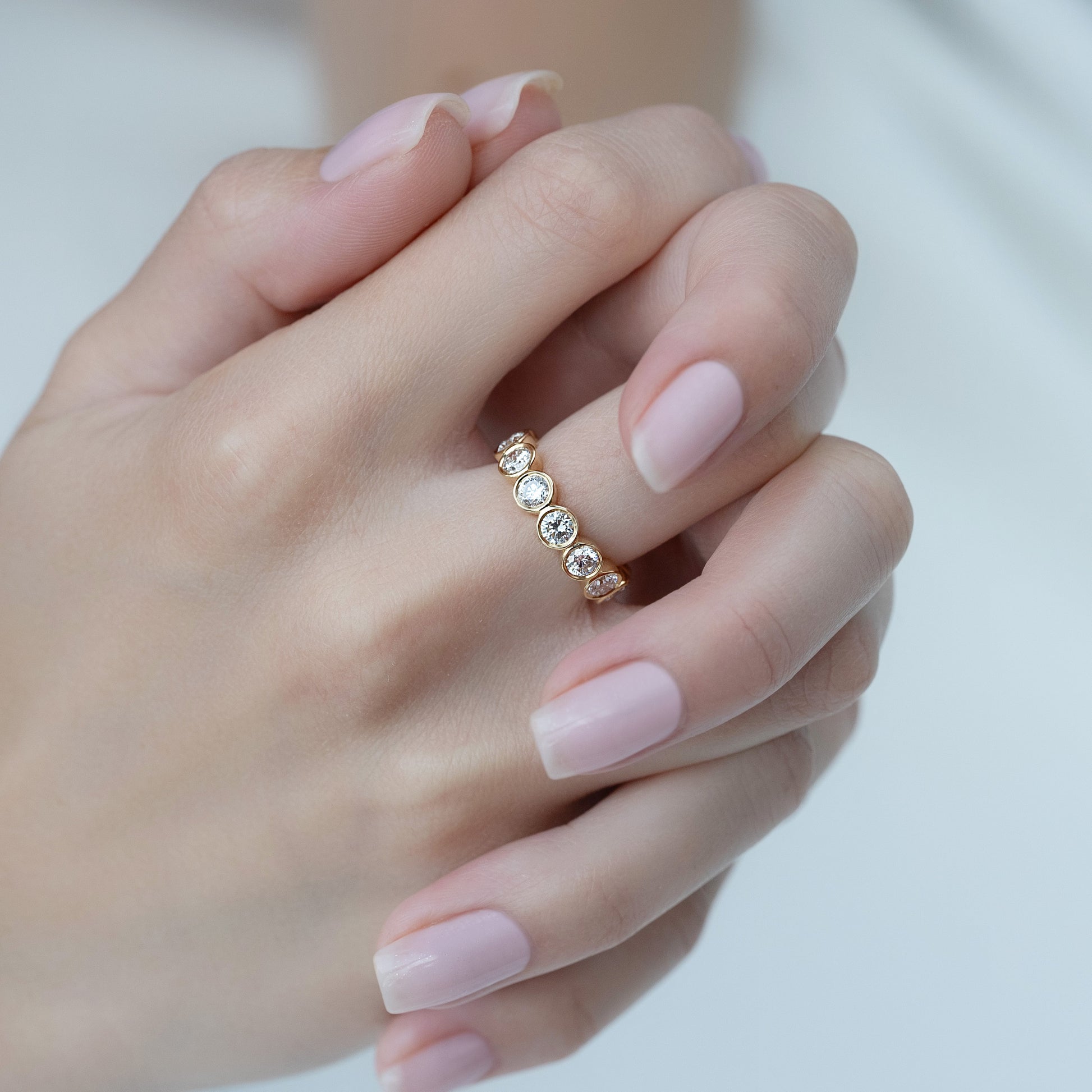 Yellow :: 3 carat round bezel set lab diamond eternity ring yellow gold full diamond band