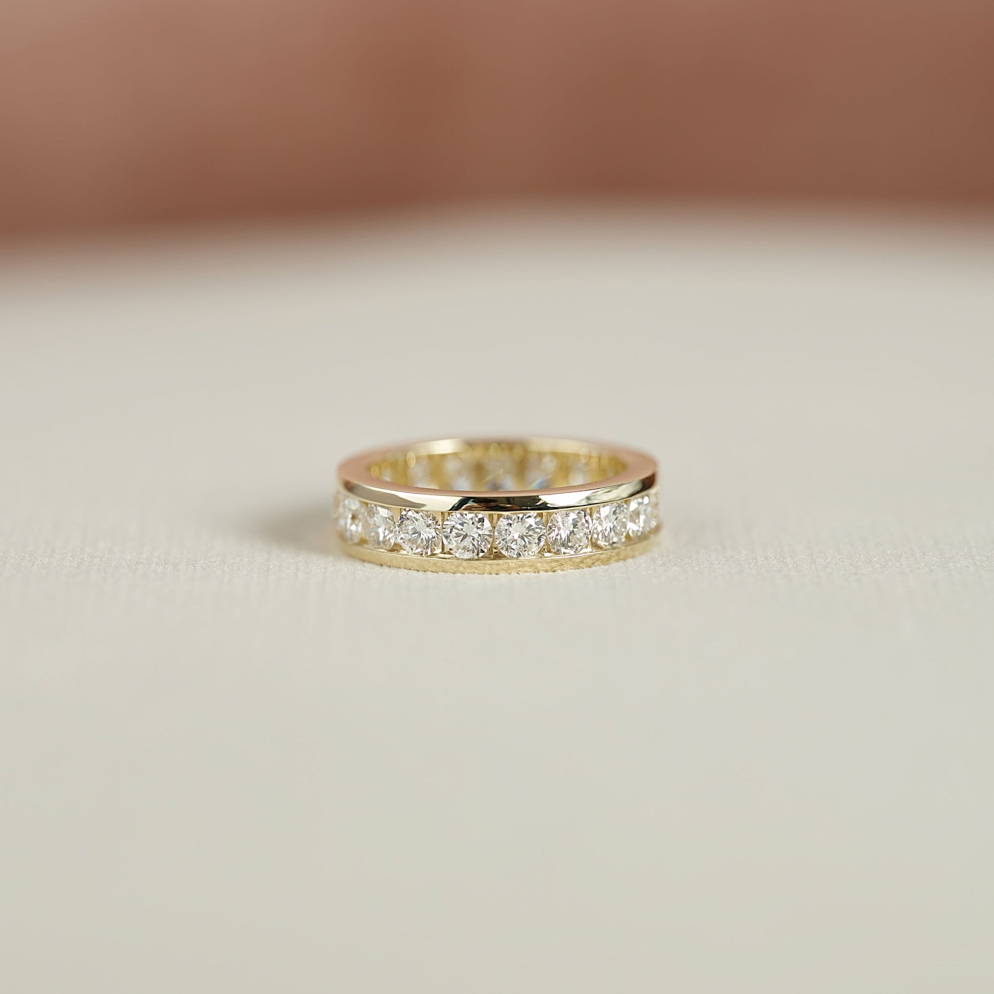 Yellow :: close up 2ct round channel lab diamond eternity ring yellow gold smooth finish