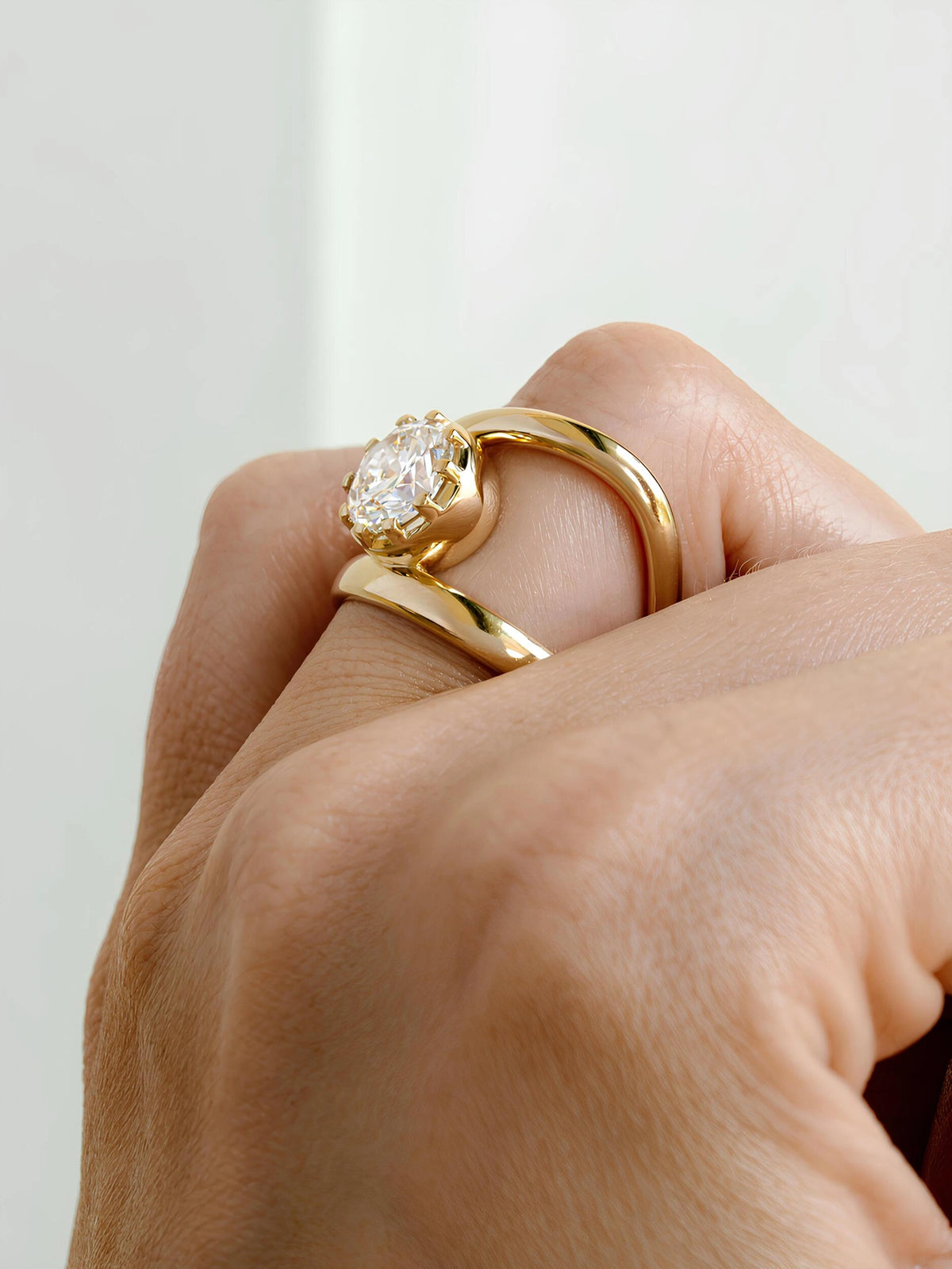 Common :: Round diamond engagement ring with polished bypass inspired metal design