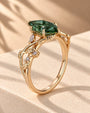 Common :: Green Marquise diamond ring with Marquise and Round accents