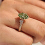 Common :: 1CT Green Oval center with D E F Round diamond accents
