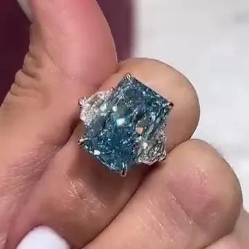 Radiant 8.00tcw Fancy Blue Lab Grown Diamond Ring | Three Stone Design with 1.00ct Cadillac Side Stones | IGI Certified | VVS-VS Clarity