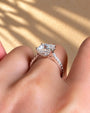 Common :: Close-up of a princess lab diamond engagement ring with hidden halo detailing.