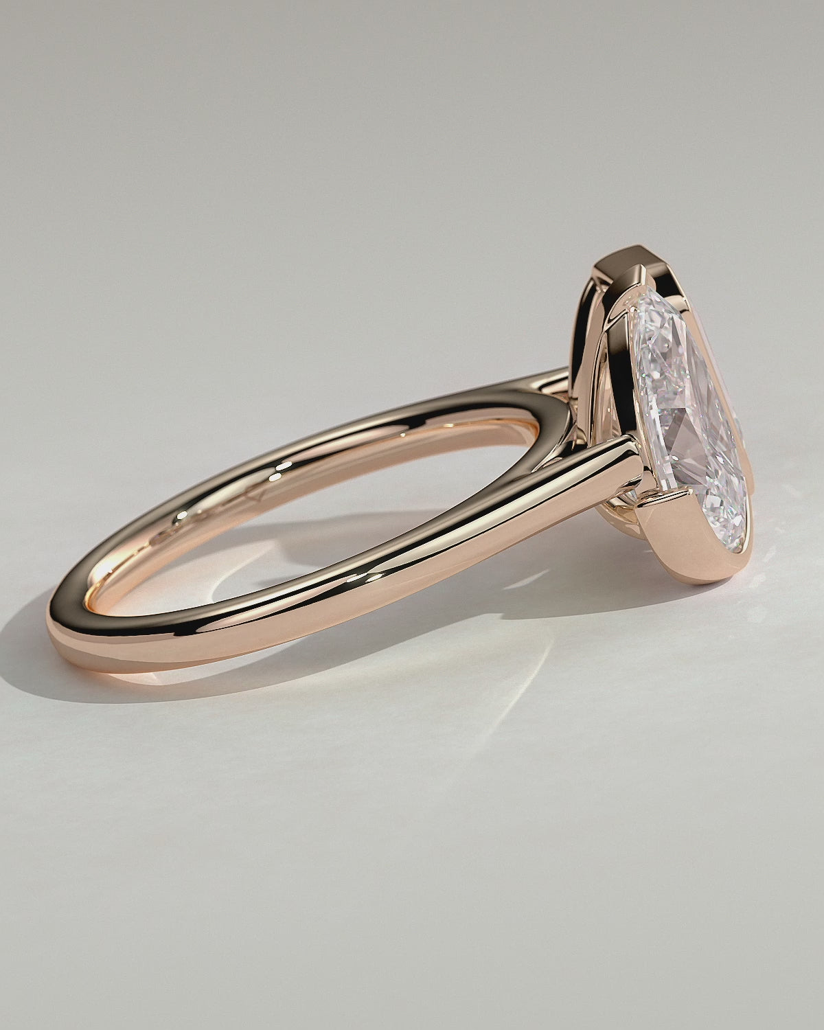 Rose :: Calvellae 3.3ct pear and 3.3ct emerald bezel toi et moi lab grown diamond engagement ring 360 view rose gold IGI certified two stone ring