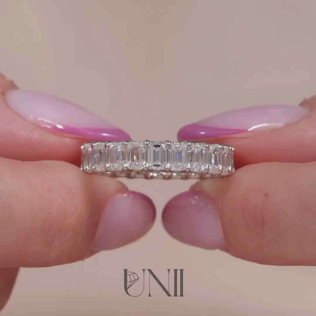 Common :: 5ct emerald cut lab grown diamond eternity ring in white gold featuring IGI certified diamonds. An ultra luxury full band with U-prong setting for maximum light exposure, delivering bold step-cut brilliance and statement styling.