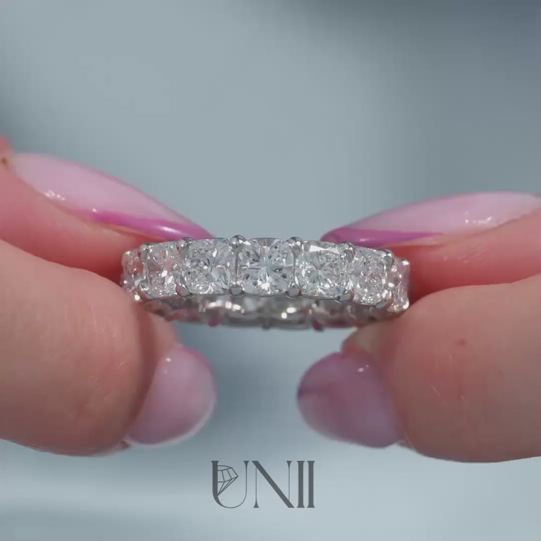 Common :: Classic 8ct cushion lab grown diamond eternity ring in yellow gold featuring IGI certified diamonds. An ultra luxury full diamond band with soft cushion edges and exceptional sparkle, perfect for milestone occasions, stacking, and statement wear.