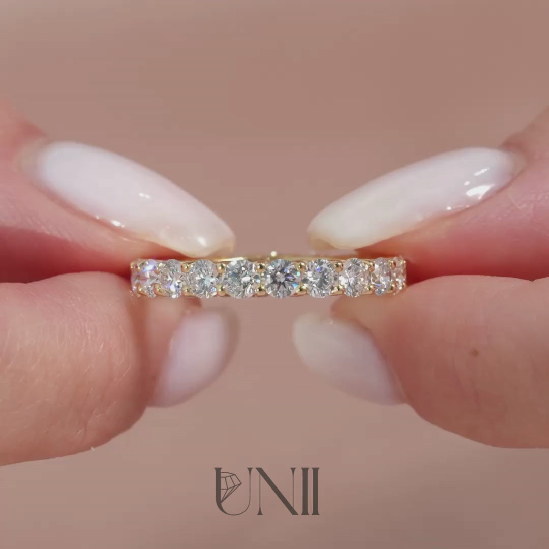 Common :: Classic 3ct round lab grown diamond eternity ring in yellow gold featuring IGI certified diamonds. A timeless full diamond band with trellis setting that enhances brilliance and adds a bold designer look.