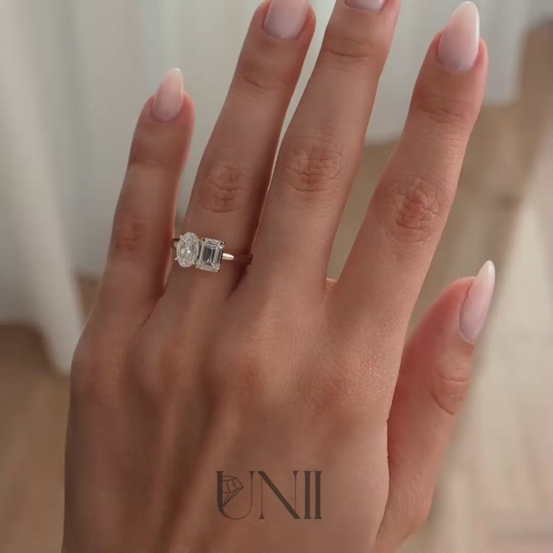 Rose :: Elegant oval and emerald lab grown diamond toi et moi engagement ring in rose gold with IGI certified diamonds. A romantic two-stone ring blending brilliance and step-cut elegance, perfect for modern luxury proposals.