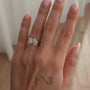 Yellow | Rose :: 1.8ct emerald and 1.5ct pear lab grown diamond toi et moi engagement ring featuring IGI certified diamonds. Designed with a hidden halo for extra brilliance, this romantic two-stone ring blends emerald-cut sophistication with pear-shaped sparkle for a modern luxury statement.