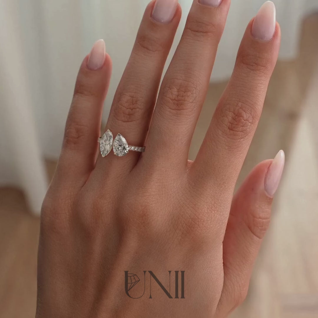 Rose | Yellow :: 1.5ct marquise and 1.8ct pear lab grown diamond toi et moi engagement ring featuring IGI certified diamonds. Designed with a pavé band for added brilliance, this two-stone ring combines sharp marquise elegance with pear sparkle for a bold modern luxury statement.
