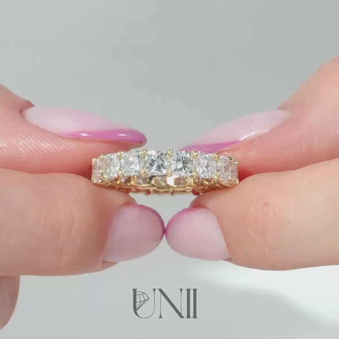 Common :: Classic 5ct cushion lab grown diamond eternity ring in yellow gold featuring IGI certified diamonds. An ultra luxury full diamond band with soft cushion edges and brilliant sparkle, perfect for weddings, stacking, and statement wear.