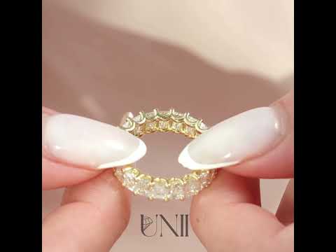 Common :: Classic 4ct emerald cut lab grown diamond eternity ring in yellow gold featuring IGI certified diamonds. A timeless full band with U-prong setting that maximizes light and showcases step-cut clarity with elegant brilliance.