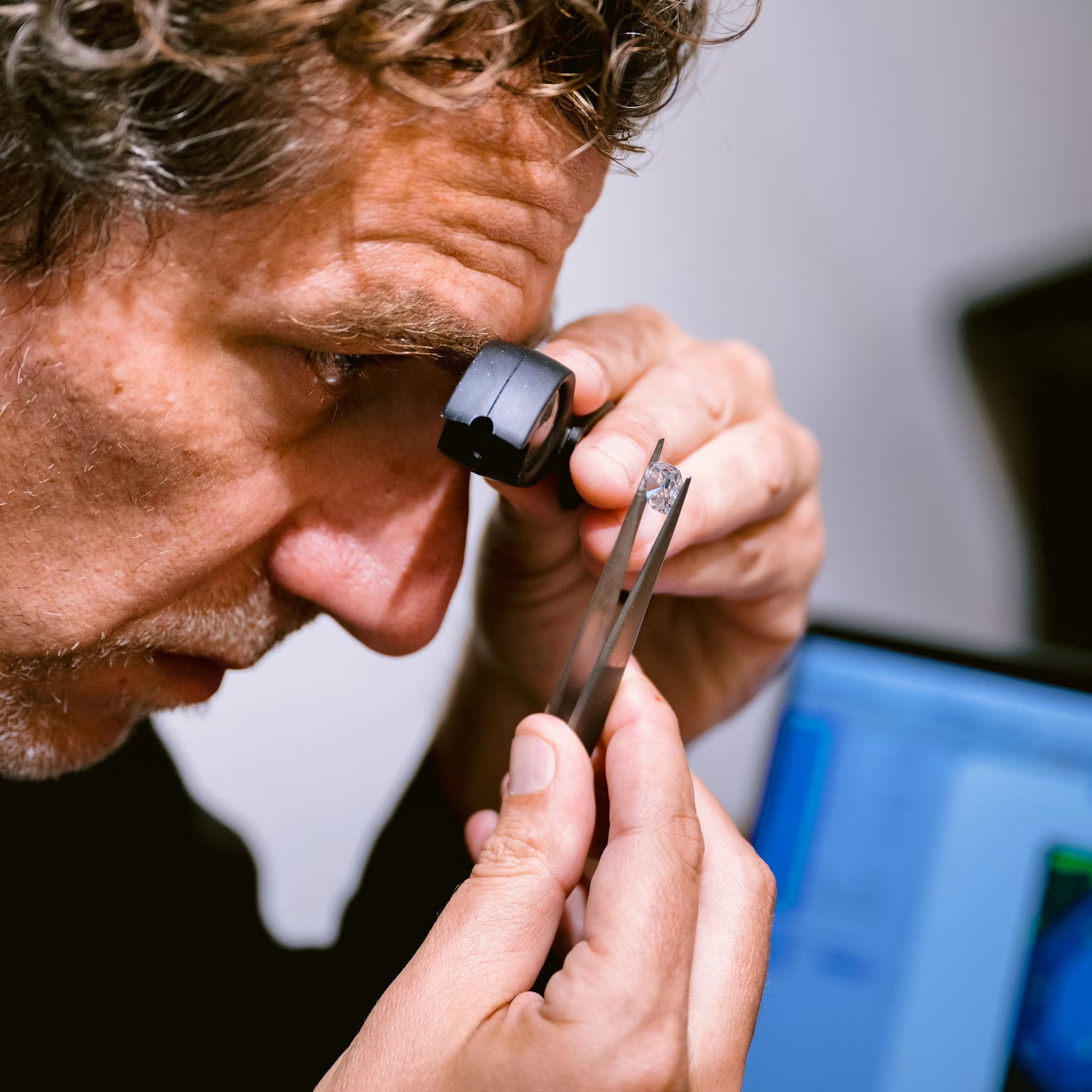 Unii Jewels expert inspecting lab grown diamond for precision cutting polishing and brilliance