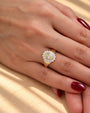 Common :: Close-up of a yellow oval diamond engagement ring with round accent diamonds